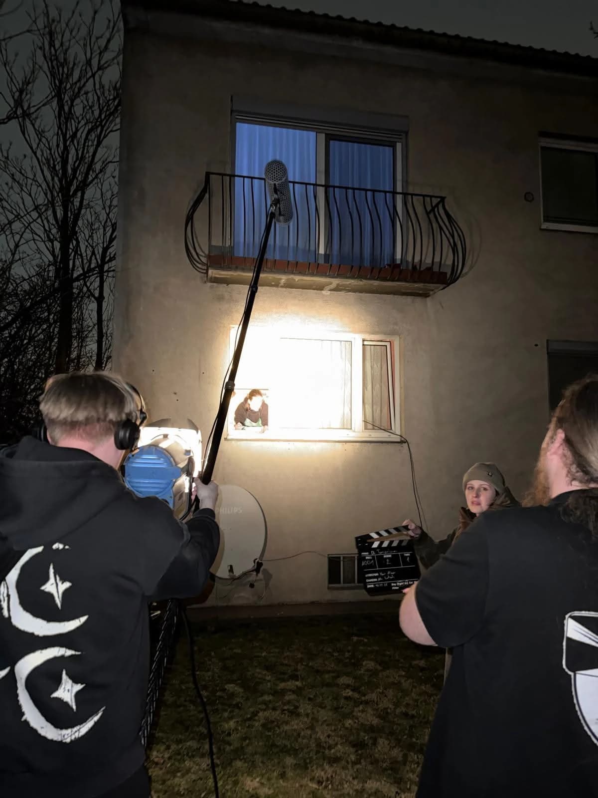 Nikolaus booming a night exterior scene outside an apartment building